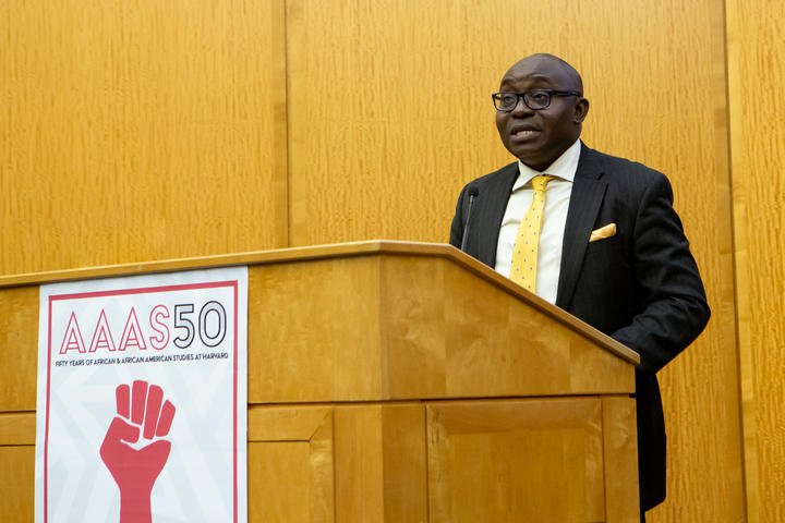 Professor Wale Adebanwi speaking at a Lectern